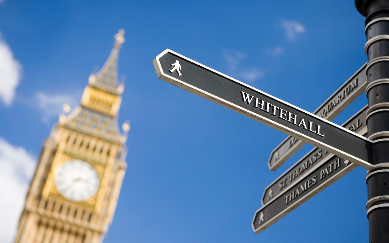 A sign pointing to Whitehall, with Parliament's Queen Elizabeth Tower in the background