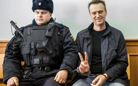 Alexei Navalny appears in court after being arrested at the March 26 protest in Moscow - Credit: Evgeny Feldman/AP Photo