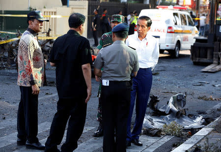 Indonesia President Joko Widodo (R) visits the burned church location at the Pentecost Church Central Surabaya (GPPS), in Surabaya, Indonesia May 13, 2018. REUTERS/Beawiharta