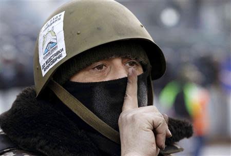 An anti-government protester gestures at the site of clashes with riot police in Kiev, January 27, 2014. REUTERS/Vasily Fedosenko