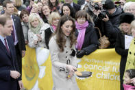 Kate got stuck in as she flipped a pancake at a display by the charity Northern Ireland Cancer Fund for Children outside Belfast City Hall during the couple's visit to Northern Ireland in March 2011. (PA Images)