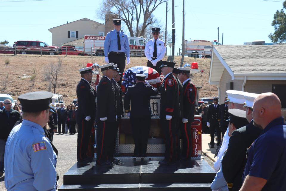 Fritch Volunteer Fire Chief Zeb Smith is placed on the top of a firetruck after a memorial service to be laid to rest in Westlawn Memorial Park just outside of Fritch on Saturday afternoon.