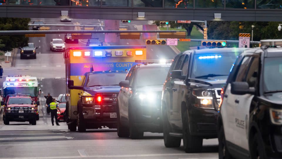 A procession including fire, police and EMS travels downtown. - Sara Diggins/Austin American-Statesman/AP