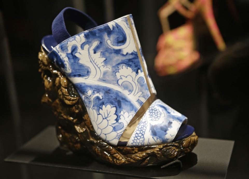 This Feb. 11, 2013 photo shows a shoe designed by Nicholas Kirkwood for the Rodarte spring 2011 fashion show that has the appearance of antique ceramic ware is displayed at the "Shoe Obsession" exhibit at The Museum at the Fashion Institute of Technology Museum in New York. The exhibition, showing off 153 specimens, runs through April 13. (AP Photo/Kathy Willens)