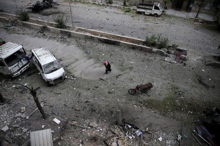 A man cleans up a damaged site after what activists said was shelling by forces loyal to Syria's President Bashar al-Assad in the Douma neighborhood of Damascus, Syria November 22, 2015. Picture taken November 22, 2015. REUTERS/Bassam Khabieh