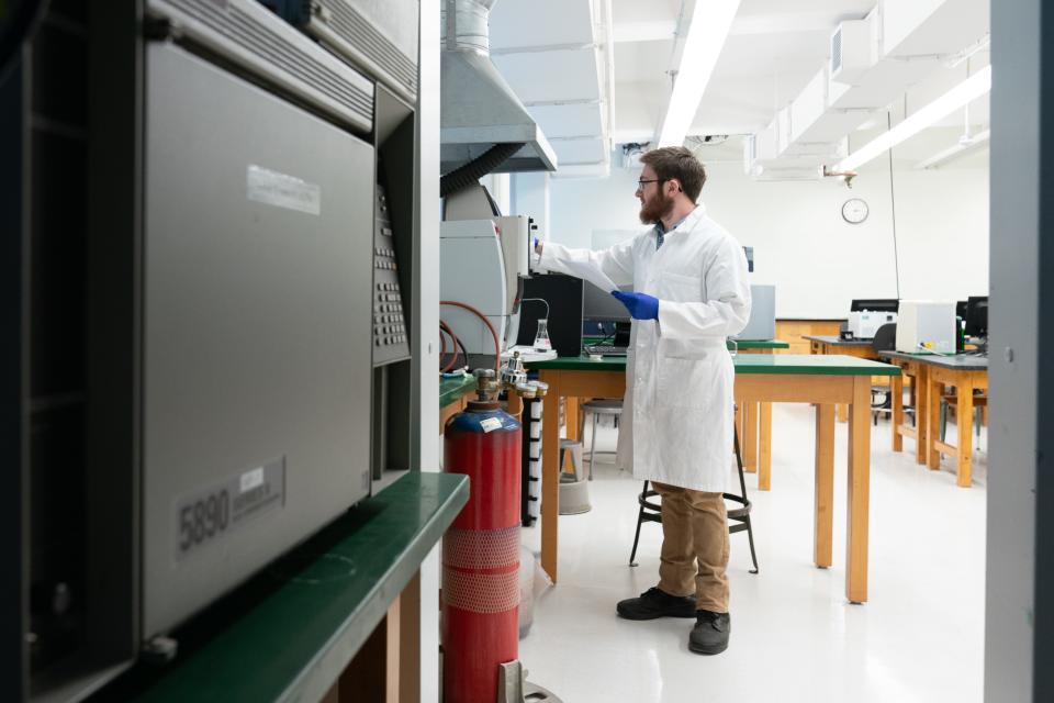 Ethan Connors, Washburn University senior in chemistry, turns on an atomic absorption spectrometer used to measure nanoparticles Thursday in a lab at Stauffer Hall. Connors says this machine, plus a UV/US spectrometer, are two methods of measuring and observing chemicals.