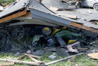 <p>A ride-on lawnmower lies under a collapsed roof in a neighbourhood destroyed by a tornado in Dunrobin, Ont., west of Ottawa, on Saturday, Sept. 22, 2018. The storm tore roofs off of homes, overturned cars and felled power lines in the Ottawa community of Dunrobin and in Gatineau, Que. (Photo from Justin Tang/The Canadian Press) </p>