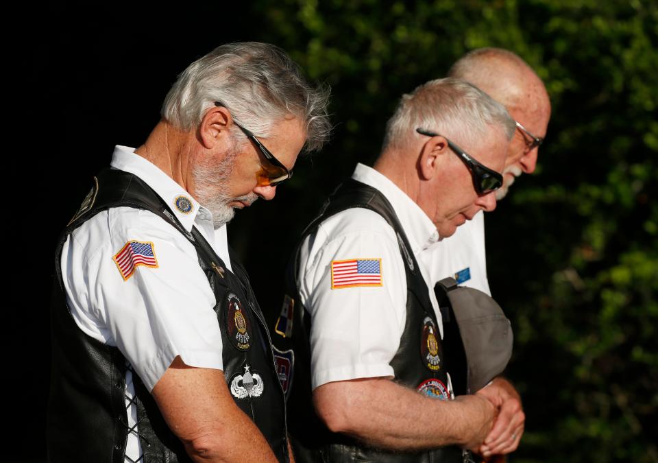 Veterans bow their heads in remembrance at a Memorial Day Ceremony in 2021 at Heroes Memorial Park in Palm Coast.