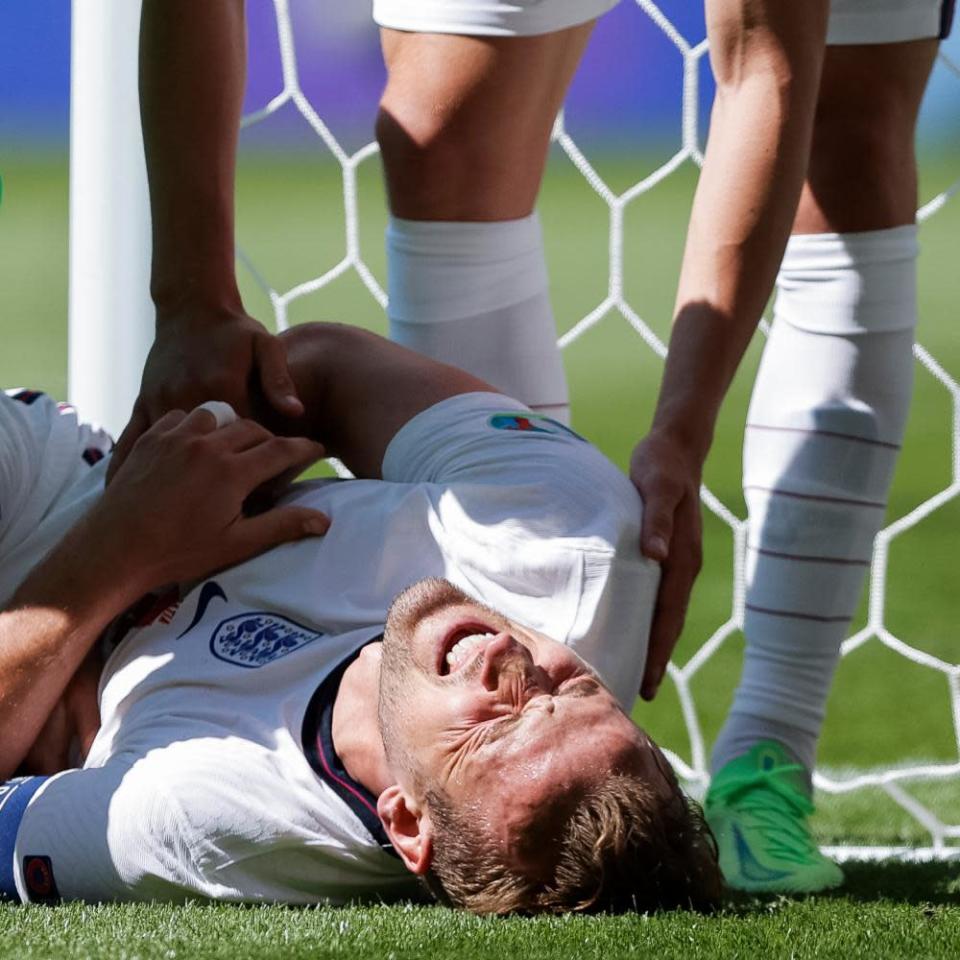 Harry Kane of England is winded after clattering into a post