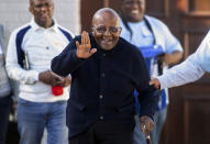 FILE - Anglican Archbishop Emeritus Desmond Tutu waves as he exits his home in Cape Town, South Africa Monday May 6, 2019. Tutu, South Africa’s Nobel Peace Prize-winning activist for racial justice and LGBT rights and retired Anglican Archbishop of Cape Town, has died, South African President Cyril Ramaphosa announced Sunday Dec. 26, 2021. He was 90. (AP Photo, File).
