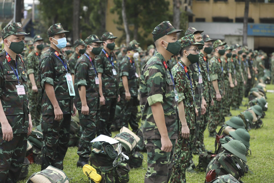 Army soldiers line up during a ceremony to send off military doctors to Ho Chi Minh City to help with treating COVID-19 patients in Hanoi, Vietnam, Monday, Aug. 23, 2021. Vietnam's largest metropolis Ho Chi Minh City has enabled a strict lockdown order to help curb the recent outbreak of the pandemic. (Bui Cuong Quyet/VNA via AP)