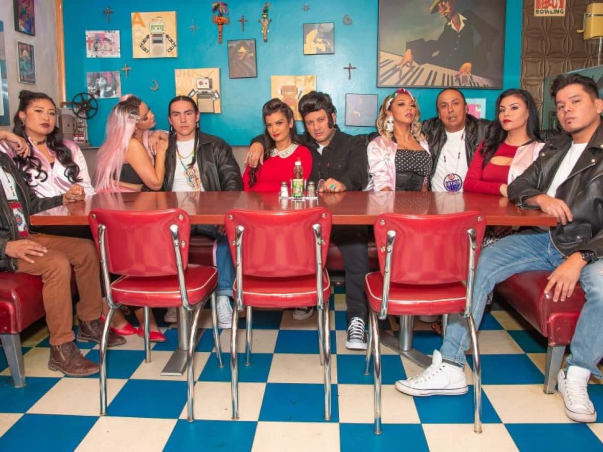 Crystle Lightning and MC Redcloud, sitting in the middle, are shown with the full cast of Bear Grease. The play is an Indigenous-focus version of the beloved 1978 movie musical Grease.  (Submitted by MC Redcloud/Bear Grease - image credit)