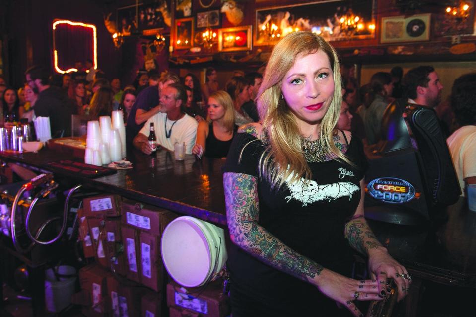 Susanne Warnekros, owner of The Jinx, takes a break from stocking the bar on a busy Saturday night.