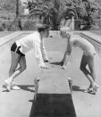 <p>Bing Crosby and his wife Dixie Lee come face to face as they lean on the diving board of their swimming pool in Rancho Santa Fe in 1935. </p>