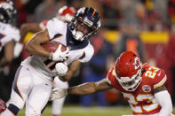 Denver Broncos' Diontae Spencer, left, returns a punt as Kansas City Chiefs' Armani Watts (23) defends during the first half of an NFL football game Sunday, Dec. 5, 2021, in Kansas City, Mo. (AP Photo/Charlie Riedel)