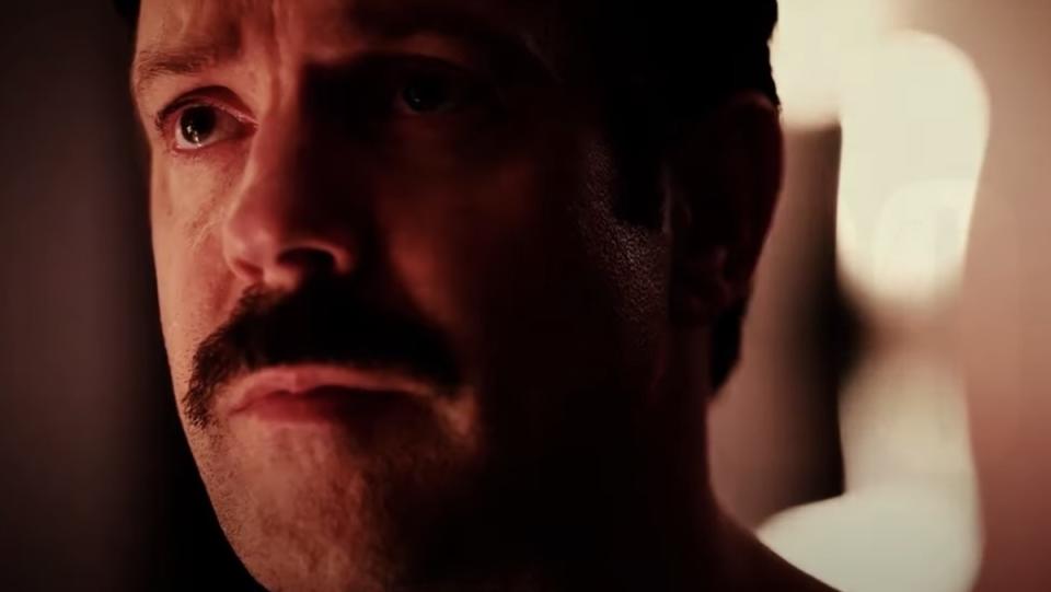 Jason Sudeikis as Ted Lasso bathed in red light