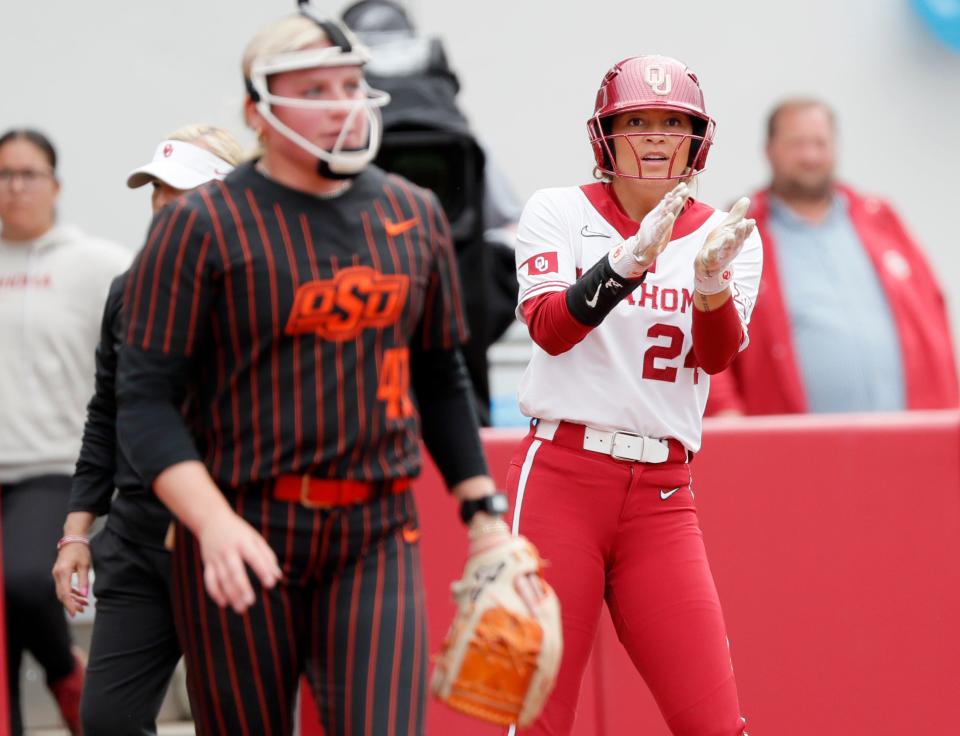 OU's Jayda Coleman (24) celebrates next to OSU pitcher Ivy Rosenberry (41) in the third inning Sunday at Love's Field in Norman.