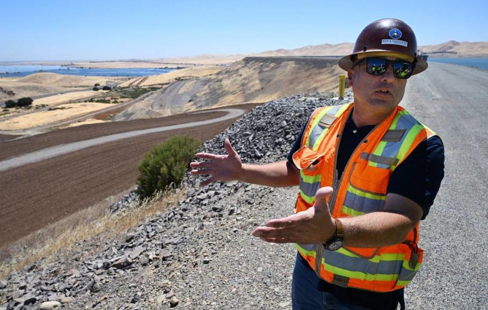 Henry Garcia, construction manager with the Bureau of Reclamation, stands on top of the B.F. Sisk Dam at San Luis Reservoir discussing the construction project which will raise the dam but impact traffic along Highway 152 over Pacheco Pass for years. Photographed Thursday, Aug. 8, 2024.