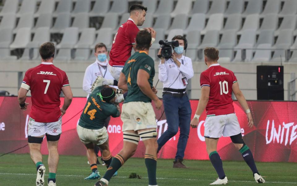 British and Irish Lions' Conor Murray, top, is tackled in the air by South Africa's Cheslin Kolbe (14) - AP