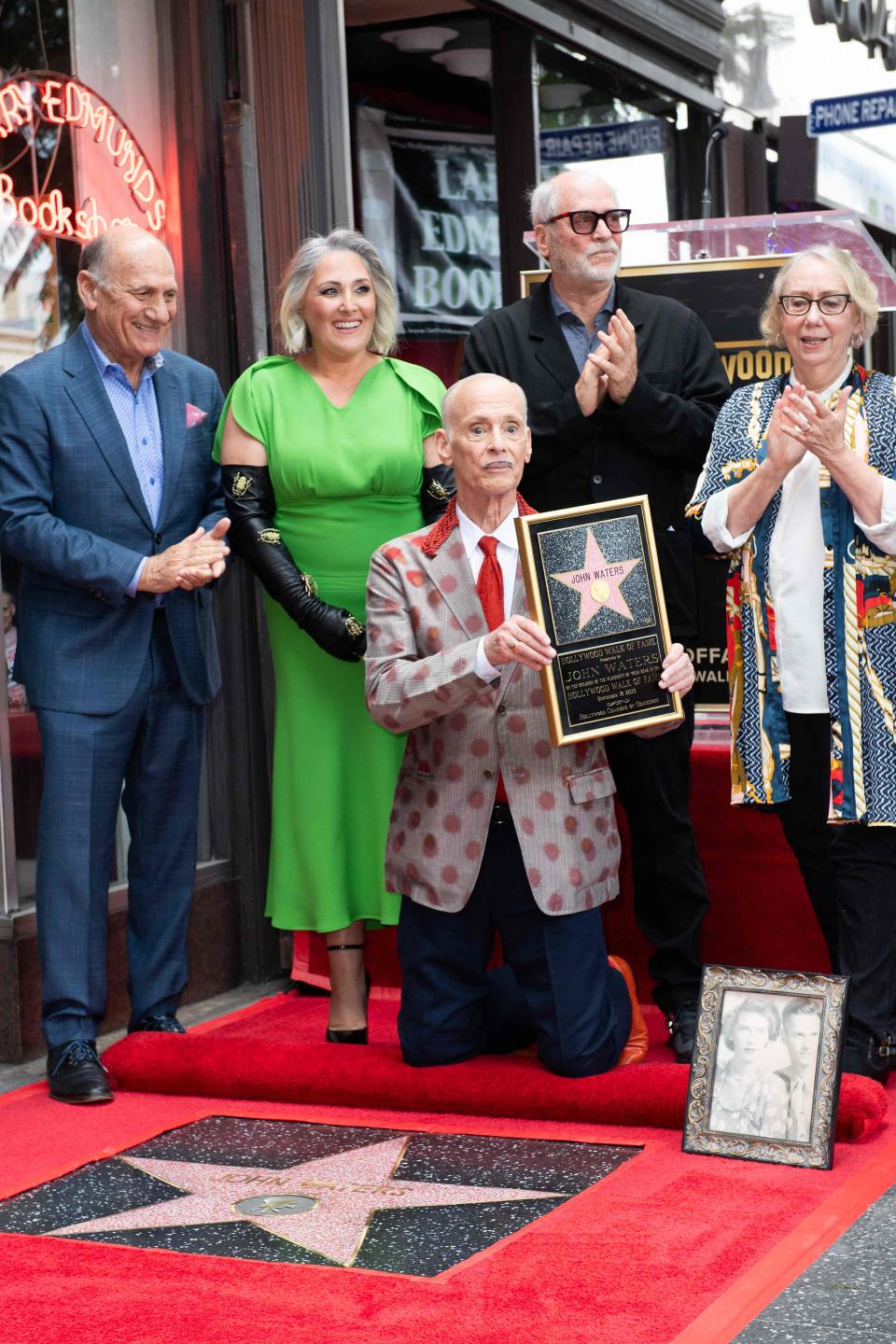From left to right: President and CEO of the Hollywood Chamber of Commerce Steve Nissen, actress Ricki Lake, director John Waters, photographer Greg Gorman, and actress Mink Stole applaud during the Hollywood Walk of Fame star ceremony honoring Waters, in Hollywood, California, on Sept. 18, 2023.