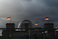 FILE - In this Friday, Nov. 29, 2019 file photo, German national flags catch the sun on top of the German parliament building, the Reichstag building in Berlin, Germany. German voters elect a new parliament on Sunday, Sept. 26, 2021, a vote that will determine who succeeds Chancellor Angela Merkel after her 16 years in power. (Photo/Markus Schreiber, File)