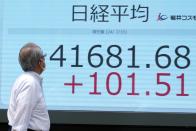 A person looks at an electronic stock board showing Japan's Nikkei index at a securities firm Wednesday, July 10, 2024, in Tokyo. (AP Photo/Eugene Hoshiko)