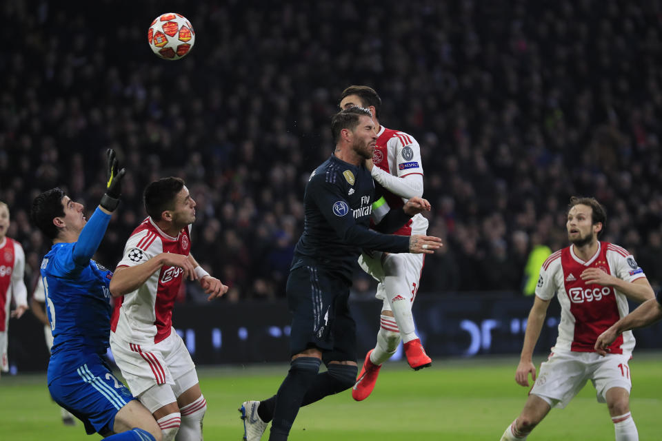 Ajax's Nicolas Tagliafico, second right, heads the ball past Real defender Sergio Ramos to scores his side's opening goal and the goal was disallowed after a review by VAR during the first leg, round of sixteen, Champions League soccer match between Ajax and Real Madrid at the Johan Cruyff ArenA in Amsterdam, Netherlands, Wednesday Feb. 13, 2019. (AP Photo/Peter Dejong)