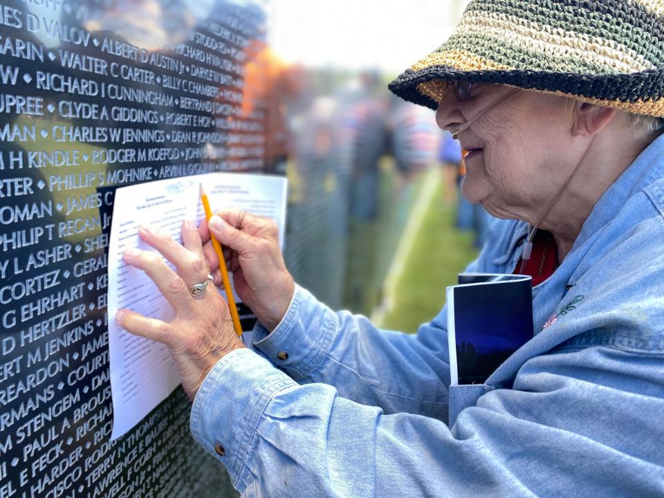 Rosella McCreary of Battle Creek traces the name of her nephew, Richard D. Orlando, on The Wall That Heals Vietnam Veterans Memorial Replica at Harper Creek Community Schools in Emmett Township on Thursday, July 14, 2022.