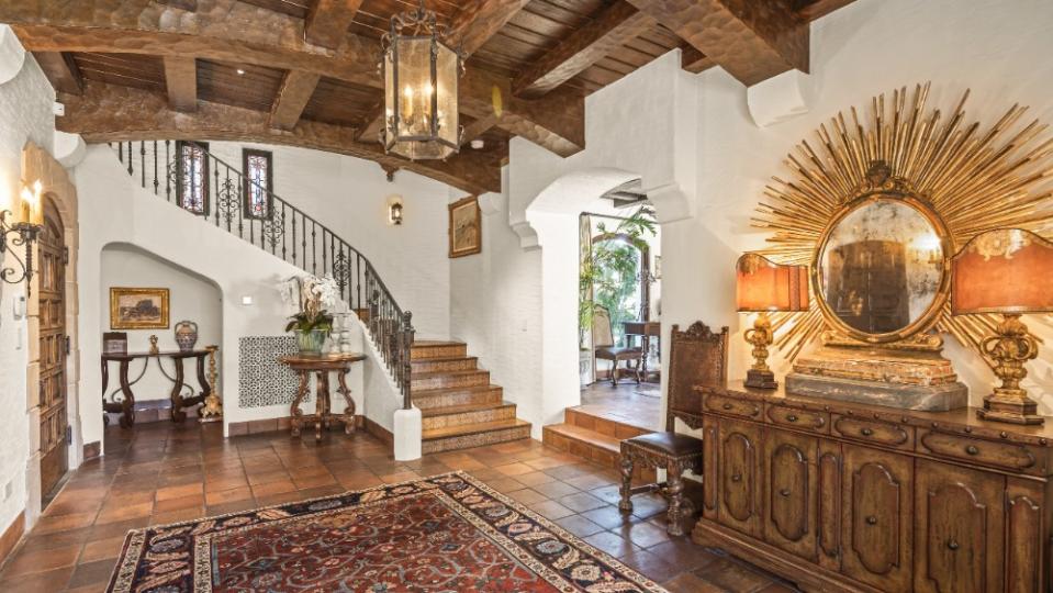 The entryway, featuring terracotta flooring and wood beams. - Credit: Michael Andrew Photography