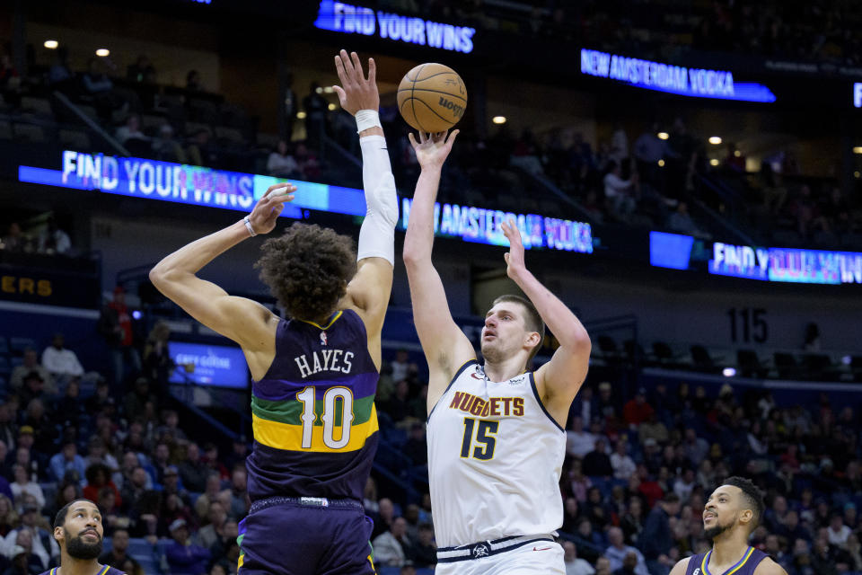 Denver Nuggets center Nikola Jokic (15) shoots over New Orleans Pelicans center Jaxson Hayes (10) in the second half of an NBA basketball game in New Orleans, Tuesday, Jan. 24, 2023. (AP Photo/Matthew Hinton)