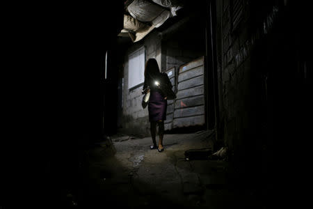 Janice Sarad, 22, who works for a bank, leaves her neighbourhood to go to work, in Antipolo City, Rizal province, Philippines, November 26, 2018. Sarad leaves her home between 4:30-5:00 a.m., to arrive at her job that starts at 8:30 a.m. "In the morning, it's even more difficult to commute because the pressure not to be late is there. You really have to fight your way in. In the evening, it doesn't matter if you get home late," she said. REUTERS/Eloisa Lopez