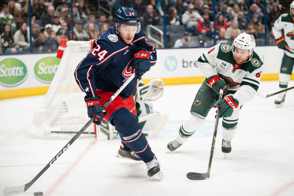 Jan 6, 2024; Columbus, Ohio, USA;
Columbus Blue Jackets right wing Mathieu Olivier (24) races towards the loose puck against Minnesota Wild defenseman Dakota Mermis (6) during the first period of their game on Saturday, Jan. 6, 2024 at Nationwide Arena.