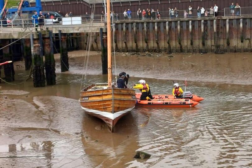 Bridlington RNLI Inshore Lifeboat (ILB) ‘Ernie Wellings’ alongside Bridlington Coble 'Three Brothers'.