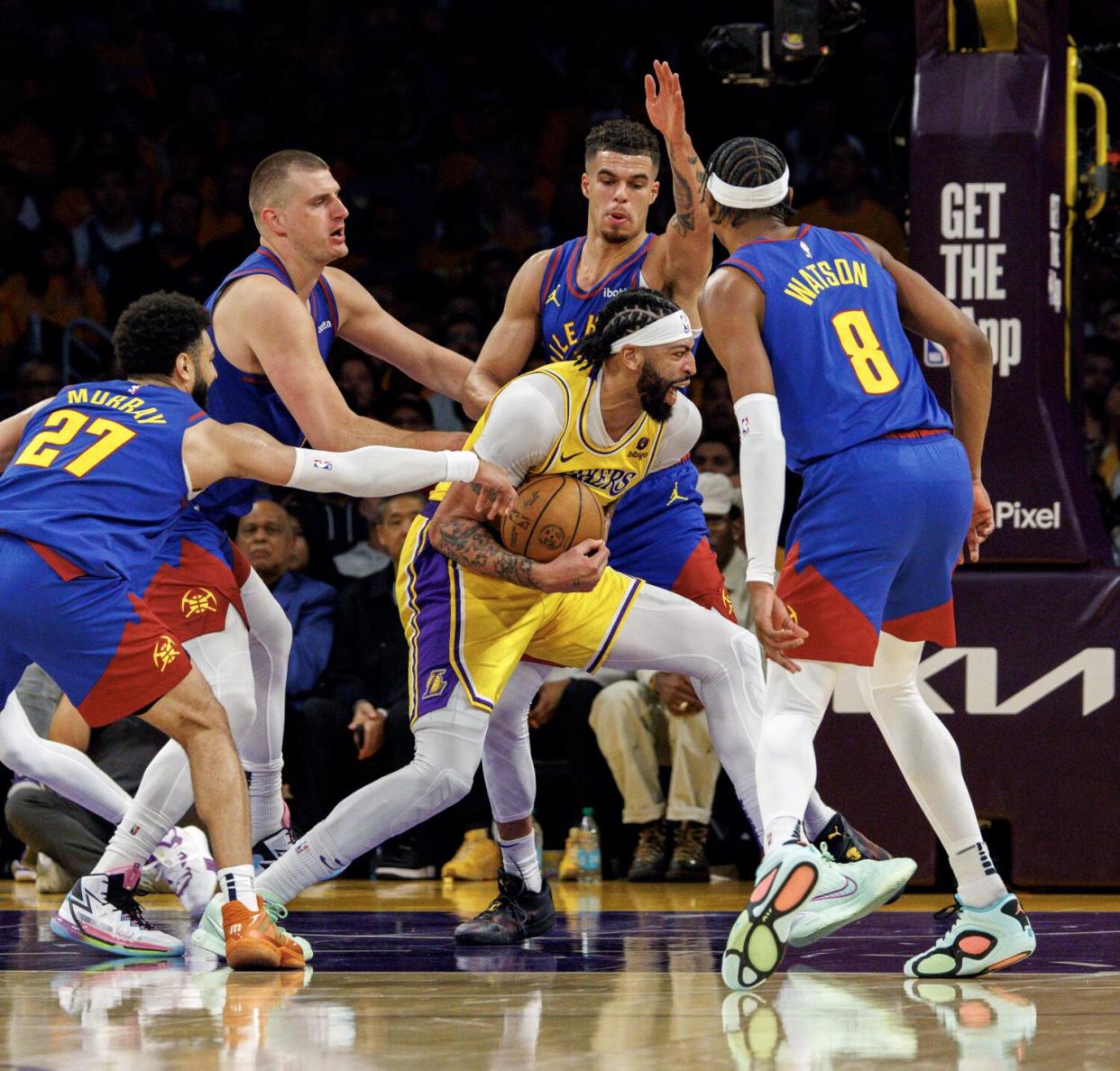 Lakers forward Anthony Davis (3) is swarmed.