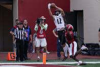 Cincinnati's Alec Pierce (12) makes a touchdown reception against Indiana's Tiawan Mullen (3) during the second half of an NCAA college football game, Saturday, Sept. 18, 2021, in Bloomington, Ind. Cincinnati won 38-24. (AP Photo/Darron Cummings)