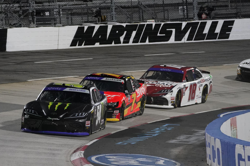 Ty Gibbs (54), Justin Allgaier (7) and Ryan Truex (18) drive through Turn 4 during the NASCAR Xfinity Series auto race at Martinsville Speedway on Friday, April 8, 2022, in Martinsville, Va. (AP Photo/Steve Helber)