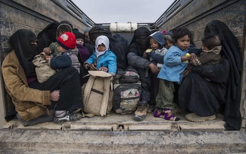 Woman and children who fled the Islamic State group's embattled holdout of Baghouz - Credit: AFP