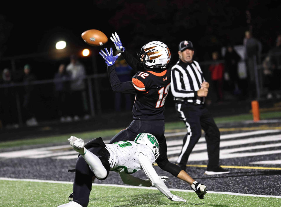 Anderson wide receiver Trace Jallick (12) catches a touchdown pass during their playoff win over Harrison Friday, Nov. 10, 2023.