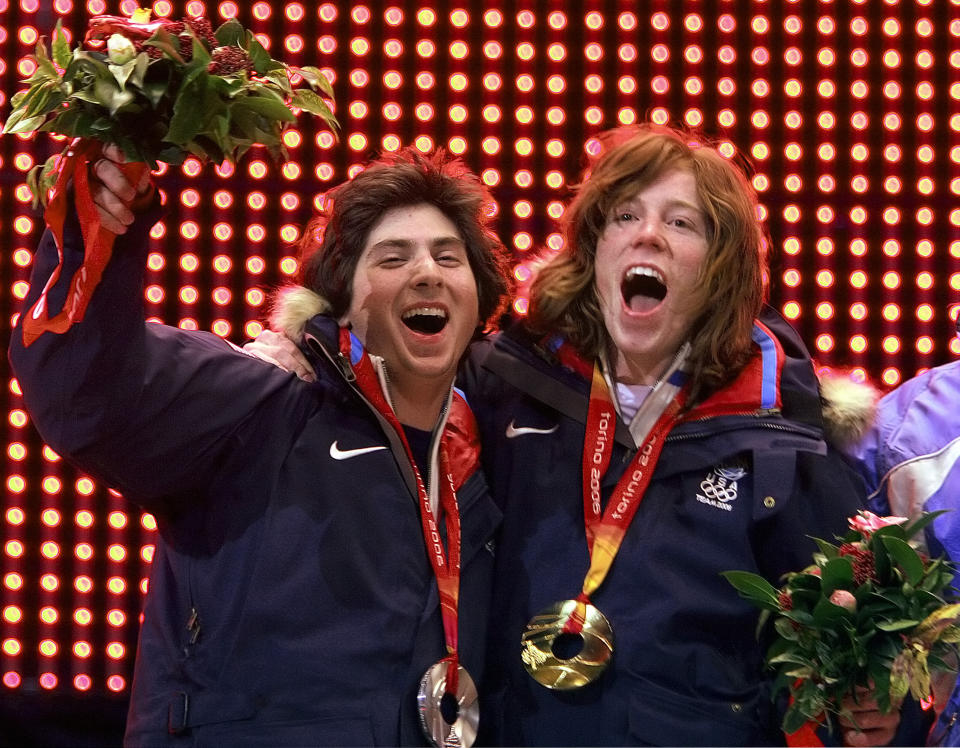 FILE - Gold medalist Shaun White, right, and silver medalist Daniel Kass, both from the United States celebrate during the medal ceremony for the snowboarding men's halfpipe at the Turin 2006 Winter Olympic Games in Turin, Italy, Sunday Feb. 12, 2006. A key part in the first episode of the documentary series “Shaun White: The Last Run” zeroes in on the exact moment White decided to try to make a living out of snowboarding instead of trying to make friends. The four-part series documenting White's life and career starts Thursday, July 6, 2023, on MAX.(AP Photo/Greg Baker, File)