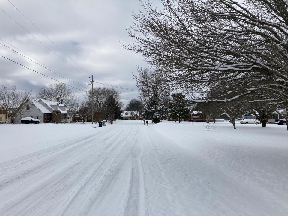 Snow covers the street and yards Tuesday (Jan. 16, 2024) in this Smyrna area neighborhood.