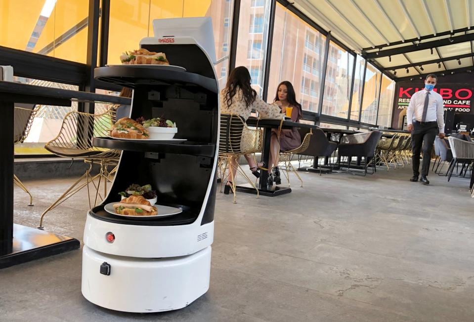 'Mozo', a robot waiter of MARSES Robotic Solutions, serves food to limit contact amid the coronavirus disease (COVID-19) at Kimbo Restaurant & Cafe in Cairo, Egypt July 28, 2020. Picture taken July 28, 2020. REUTERS/Ahmed Fahmy