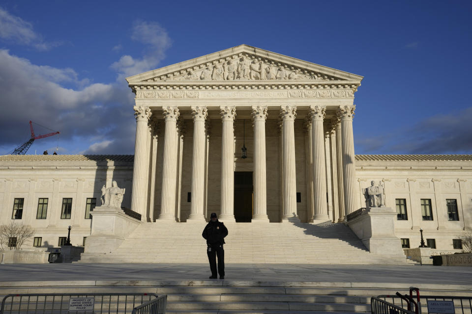 FILE - Security stands outside the U.S. Supreme Court, Jan. 20, 2023, in Washington. (AP Photo/Alex Brandon, File)