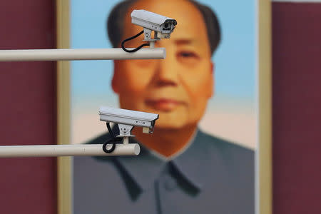 FILE PHOTO: Security cameras are seen in front of a portrait of the late Chinese Chairman Mao Zedong at the Tiananmen gate in Beijing, China, November 8, 2017. REUTERS/Damir Sagolj/File Photo