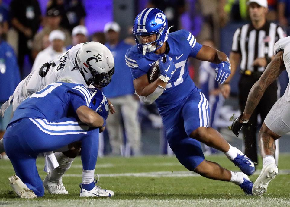 Brigham Young Cougars running back LJ Martin (27) runs with the ball as the Brigham Young Cougars play the Cincinnati Bearcats in the second half of a football game at LaVell Edwards Stadium in Provo on Friday, Sept. 29, 2023. BYU won 35-27. | Kristin Murphy, Deseret News