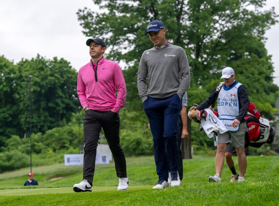 Rory McIlroy, left, and Justin Thomas walk down the ninth fairway Thursday during the first round of the RBC Canadian Open.
