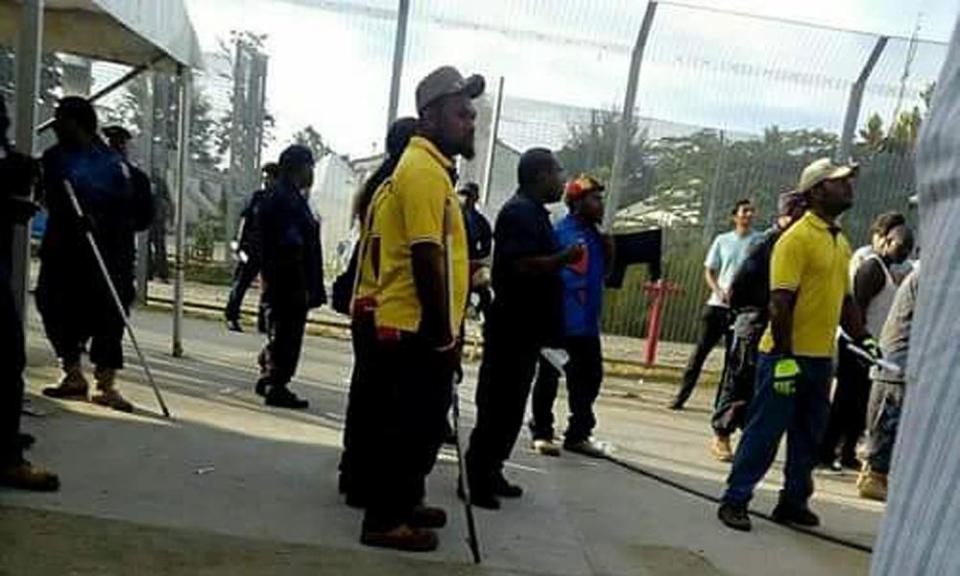 Papua New Guinean police officers enter the Manus Island immigration detention centre in PNG