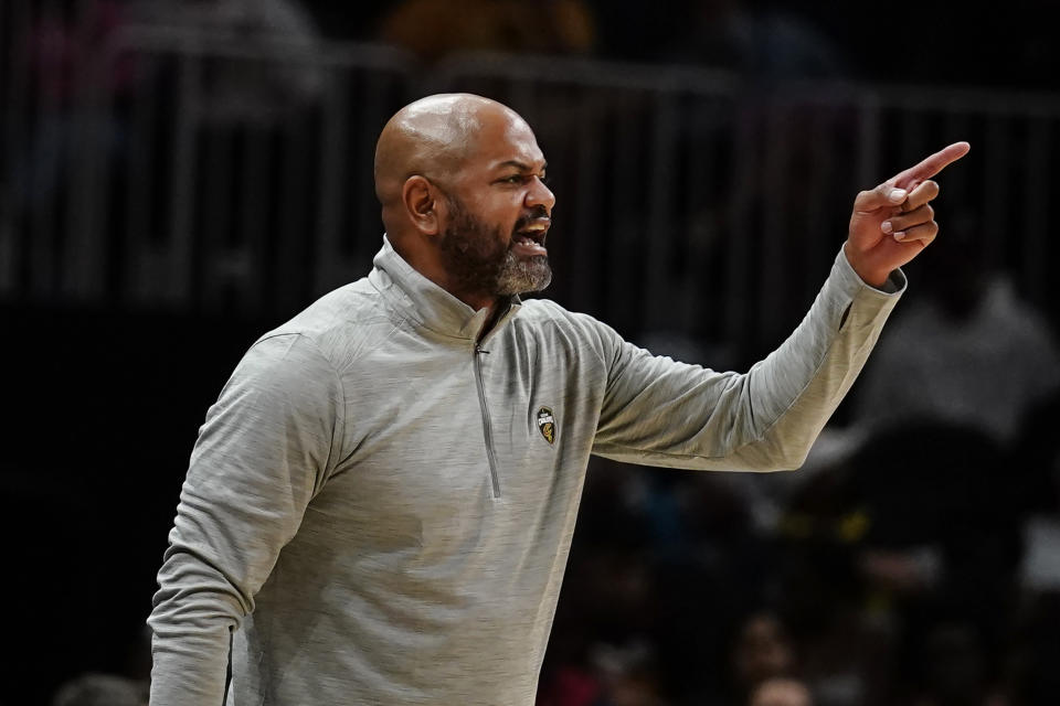 Cleveland Cavaliers coach J.B. Bickerstaff yells to players on the floor during the second half of the team's NBA preseason basketball game against the Atlanta Hawks on Wednesday, Oct. 6, 2021, in Atlanta. (AP Photo/John Bazemore)