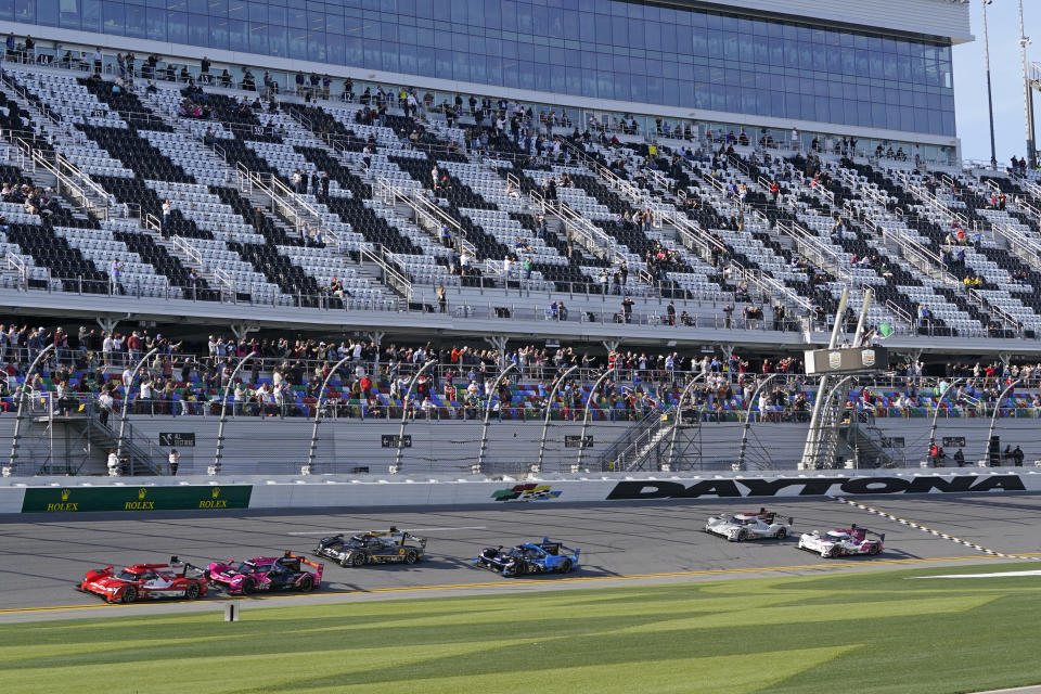 Felipe Nasr, far left, of Brazil, leads the field to start of the Rolex 24 hour auto race at Daytona International Speedway, Saturday, Jan. 30, 2021, in Daytona Beach, Fla. (AP Photo/John Raoux)