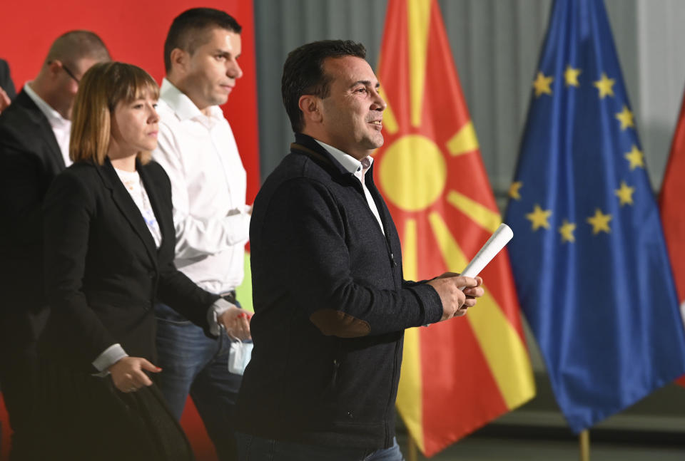 North Macedonia's Prime Minister Zoran Zaev, center, walks following a news conference at the party headquarters in Skopje, North Macedonia, late Sunday, Oct. 31, 2021. Zaev announced his resignation as prime minister and leader of Social-democratic Union after oppositional center-right coalition won a landslide victory on local elections. (AP Photo)