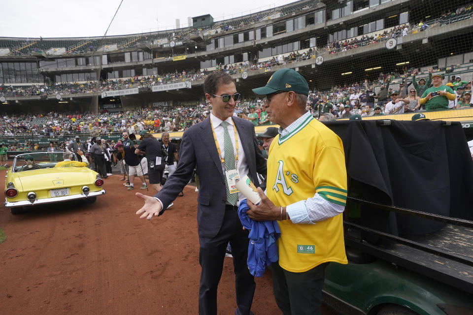 FILE - Oakland Athletics President Dave Kaval, left, talks to Reggie Jackson during a celebration of the Athletics' 1972 World Series winning team before a baseball game between the Athletics and the Boston Red Sox in Oakland, Calif., June 4, 2022. The Oakland Athletics have spent years trying to get a new stadium while watching Bay Area neighbors the Giants, Warriors, 49ers and Raiders successfully move into state-of-the-art venues, and now time is running short on their efforts. (AP Photo/Jeff Chiu, File)